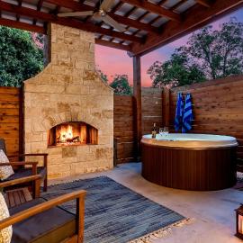 An Enchanted Hideaway outdoor fireplace hot tub