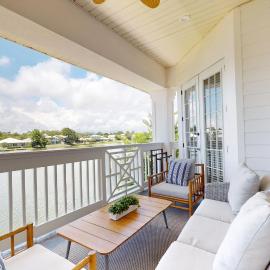 Lakefront condo with water-view balcony private golf cart resort pool & amenities