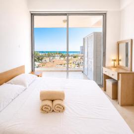 Relaxing Sea View & Sunrise from your Bed, 2-BDR Apt in tallest building in Larnaca - 3 min walk to Beach, by Blue Palm Living