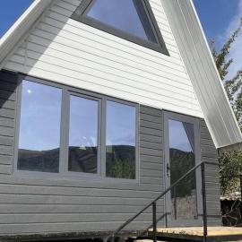 A frame house with a view of mountains, hotel in Karakol