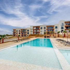 Gorgeous dog-friendly apartment with balcony, open layout, heated pool, & AC