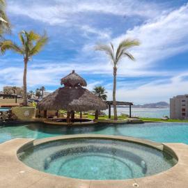 Stylish Coastal Retreat with Breathtaking Views, Resort Pool & Private Balcony