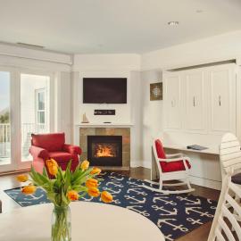 Experience luxury at Captain Suite 219 in Bay Harbor, MI, featuring a cozy bedroom and village view.