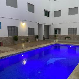 residential unit with a swimming pool and parking