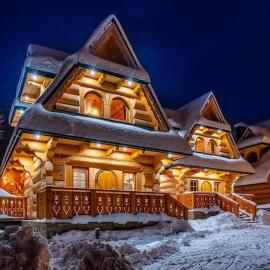 A large mountain-style house with a spa area