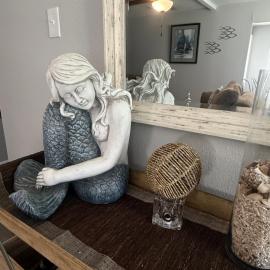 Mermaid by the coast near refineries and beach
