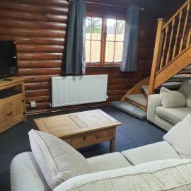 large log cabin overlooking a fishing lake, hotel a North Somercotes