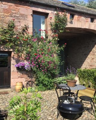 Historic converted byre in courtyard of 16C house