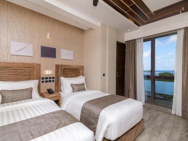 Samann Grand : photo 7 de la chambre hébergement double ou lits jumeaux deluxe avec balcon - vue sur océan (navette aéroport aller-retour gratuite)