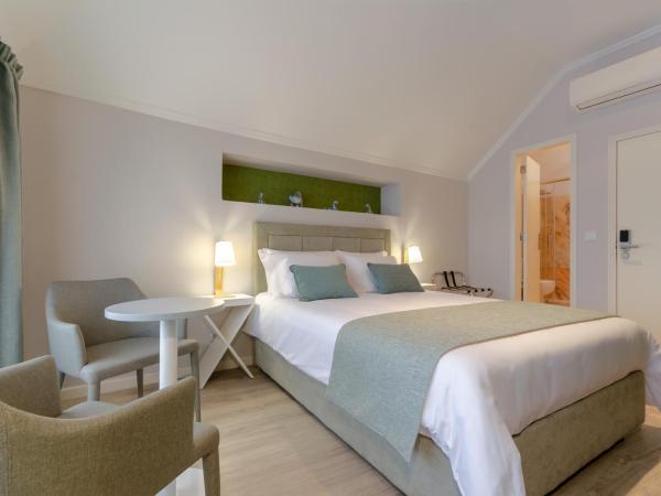 Ver Belém Suites : photo 6 de la chambre chambre lit queen-size - vue sur jardin