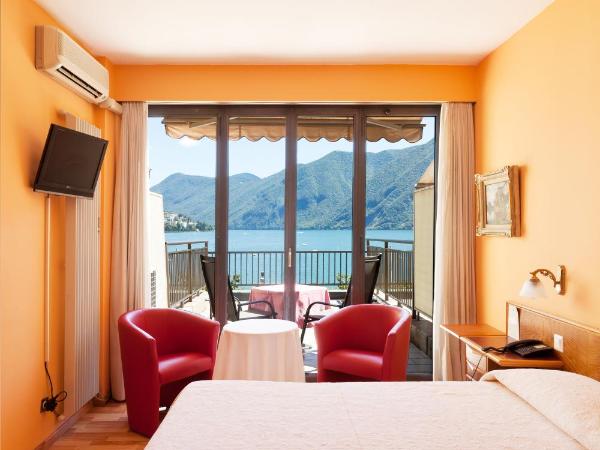Swiss Lodge Nassa Garni : photo 7 de la chambre chambre double supérieure avec terrasse et vue sur le lac

