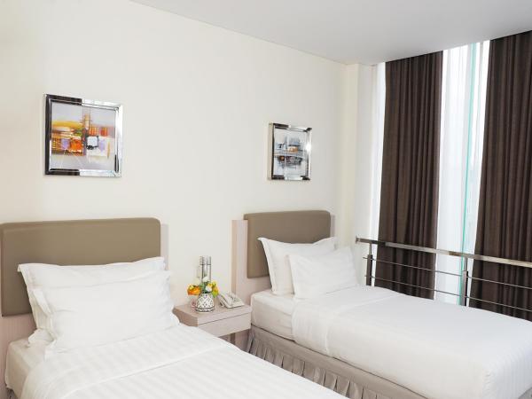 d'primahotel Melawai - Blok M : photo 4 de la chambre chambre deluxe double ou lits jumeaux