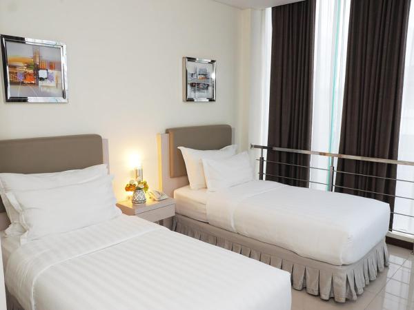 d'primahotel Melawai - Blok M : photo 5 de la chambre chambre deluxe double ou lits jumeaux