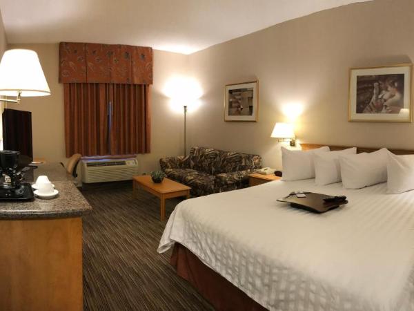 Humphry Inn and Suites : photo 6 de la chambre chambre lit king-size avec bureau