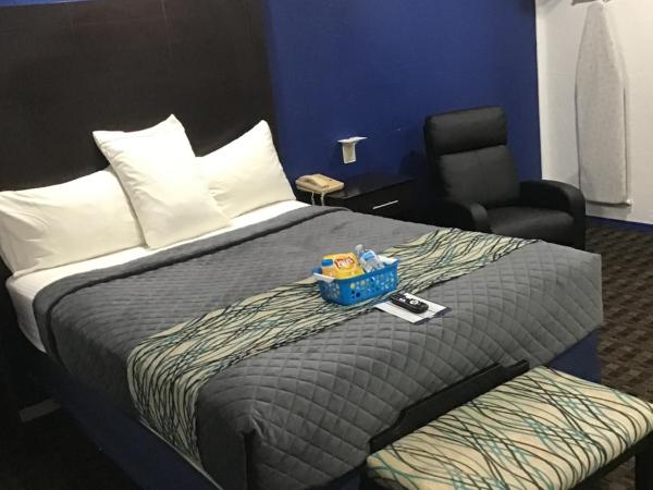 Budget Inn & Suites : photo 1 de la chambre suite lit queen-size deluxe