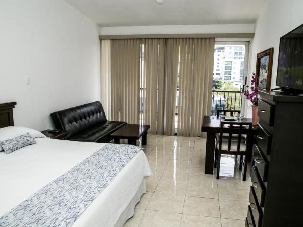 Booking Dioh : photo 4 de la chambre suite lit king-size avec balcon