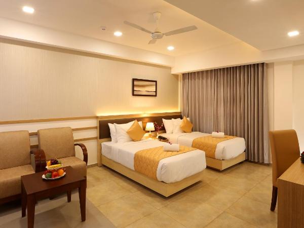 Flora Charishma Residency Aluva : photo 5 de la chambre chambre deluxe double ou lits jumeaux