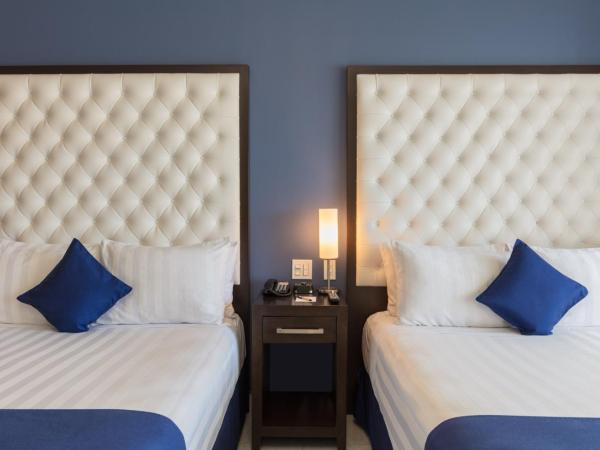 Medano Hotel and Spa : photo 3 de la chambre chambre de luxe avec 2 lits queen-size.