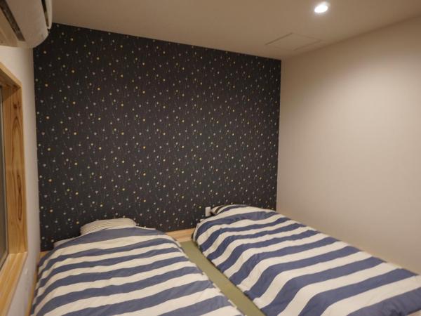 Villa Kyoto Saiin : photo 8 de la chambre chambre lits jumeaux avec matelas futon et salle de bains commune