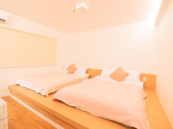 Huayuanhouse HQ in hongdae : photo 2 de la chambre chambre double supérieure avec deux lits doubles