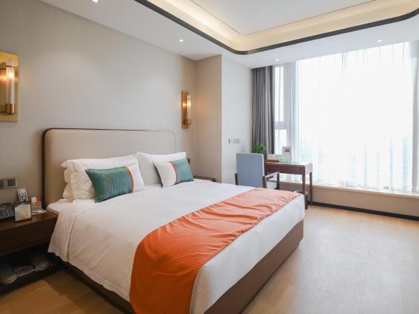 Jinling Funhome Hotel Nanjing Jiulong Lake - Nanjing South Railway Station : photo 1 de la chambre studio avec vue sur jardin