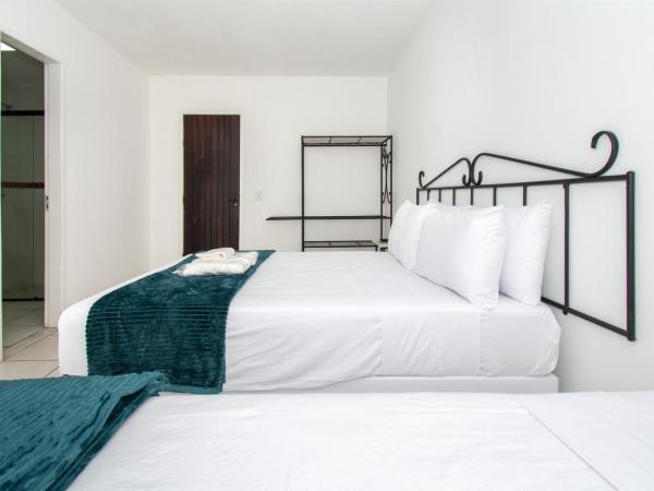 Pousada Casuarina Ferradura : photo 1 de la chambre chambre triple