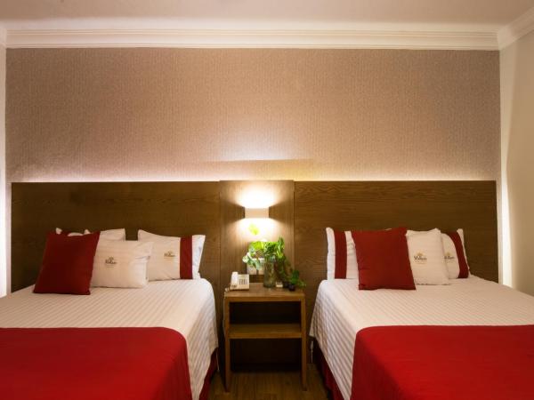 Del Marques Hotel and Suites : photo 1 de la chambre suite avec 2 lits queen-size