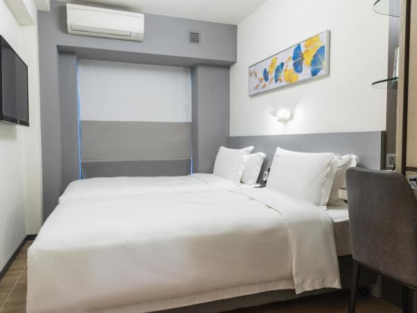City Inn Macau : photo 2 de la chambre chambre deluxe double ou lits jumeaux
