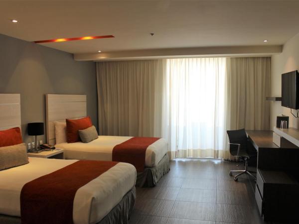 Real Inn Cancún : photo 4 de la chambre hébergement deluxe avec 2 lits - vue sur boulevard