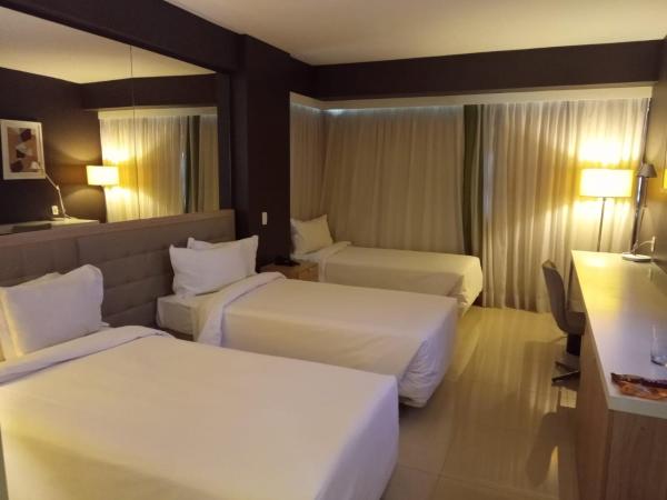 eSuites Savassi Toscanini : photo 4 de la chambre chambre triple supérieure