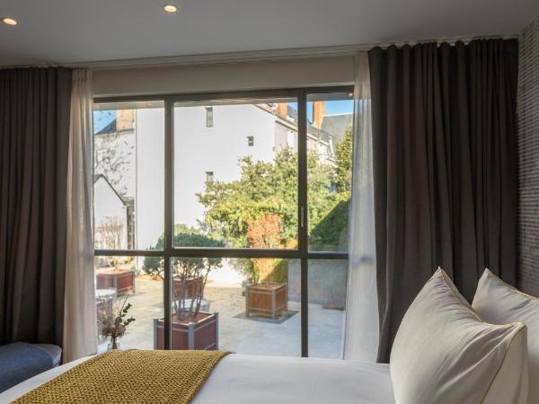 Les Trésorières : photo 1 de la chambre chambre double deluxe (annexe « le cube »)