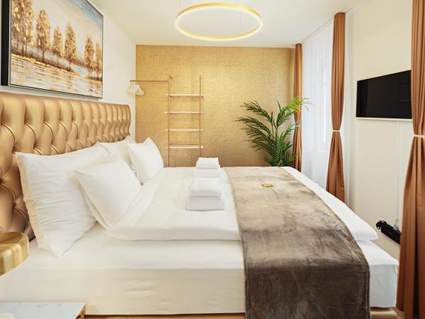 EH Apartments Merkur : photo 10 de la chambre suite supérieure lit king-size