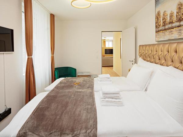 EH Apartments Merkur : photo 9 de la chambre suite supérieure lit king-size