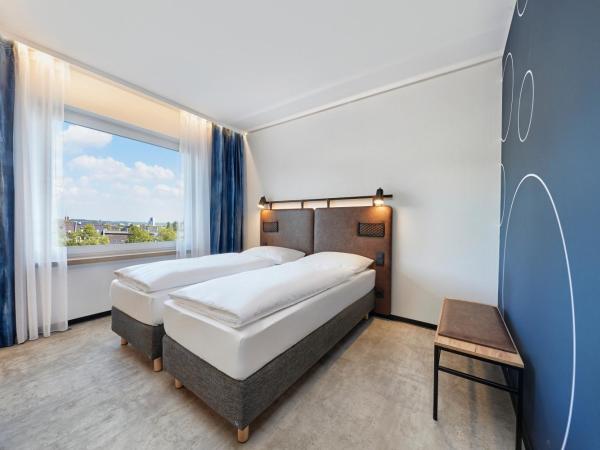 H2 Hotel Düsseldorf City : photo 1 de la chambre chambre lits jumeaux standard