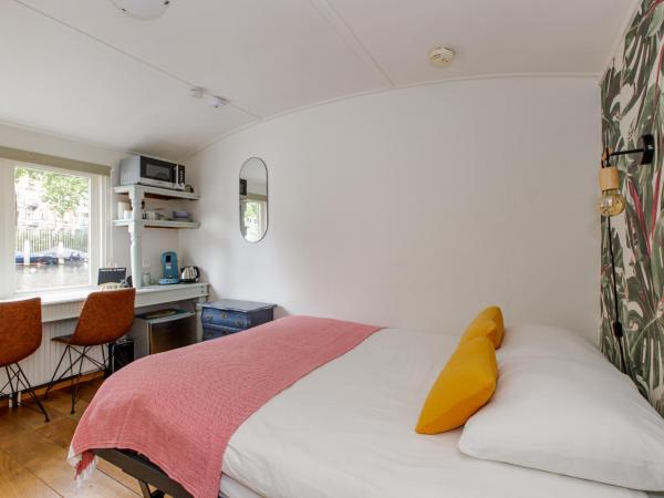 The Amsterdam Houseboat Family - de Jordaan : photo 3 de la chambre ce petit studio est aménagé sur la péniche.