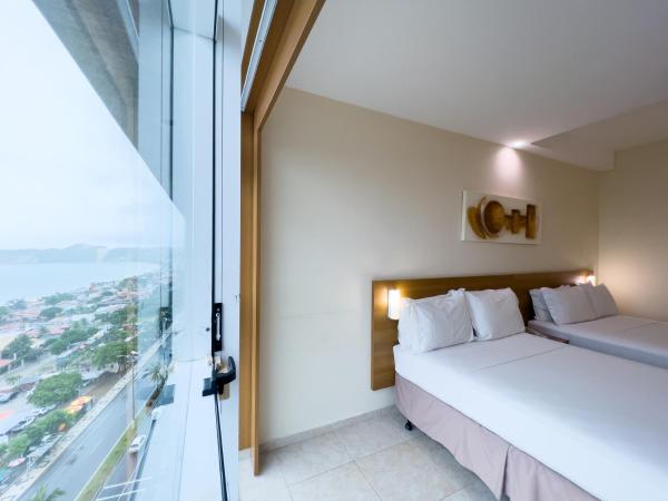 Praiamar Express Hotel : photo 1 de la chambre chambre supérieure avec 2 lits doubles - vue sur mer