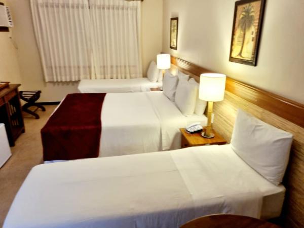 Pousada Corsario Buzios : photo 1 de la chambre chambre quadruple - vue sur jardin