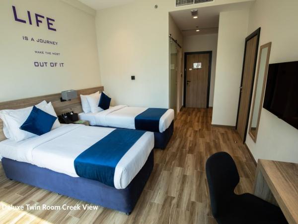 Grand Kingsgate Jaddaf Waterfront Hotel by Millennium : photo 2 de la chambre deluxe room twin bed with waterfront view