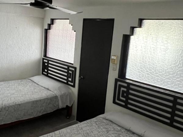 Hotel magallanes con cocineta 100 Metros de playa : photo 2 de la chambre chambre lits jumeaux avec salle de bains privative