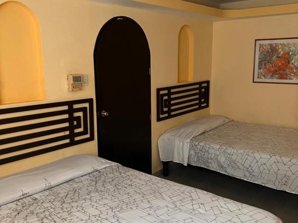 Hotel magallanes con cocineta 100 Metros de playa : photo 3 de la chambre chambre lits jumeaux avec salle de bains privative