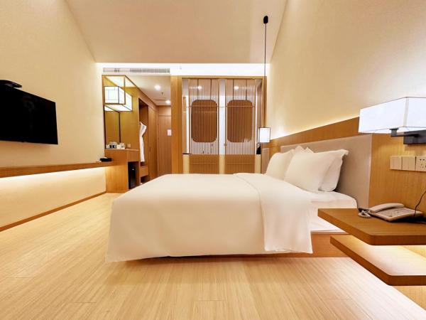 无锡花园大酒店 : photo 1 de la chambre chambre lit king-size - vue sur jardin