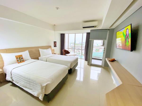 Harper MT Haryono by ASTON : photo 4 de la chambre chambre deluxe double ou lits jumeaux