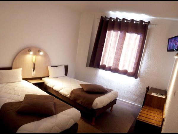 Adonis Lourdes - Notre Dame de la Sarte : photo 2 de la chambre chambre lits jumeaux - vue sur patio