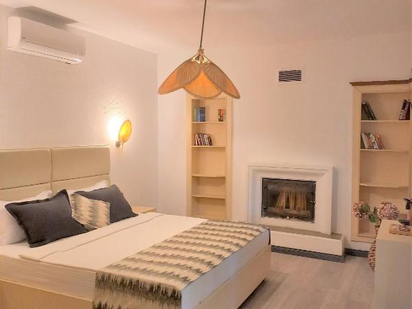 Dolce Vita Luxury Bungalows : photo 7 de la chambre maison en pierre avec cheminée