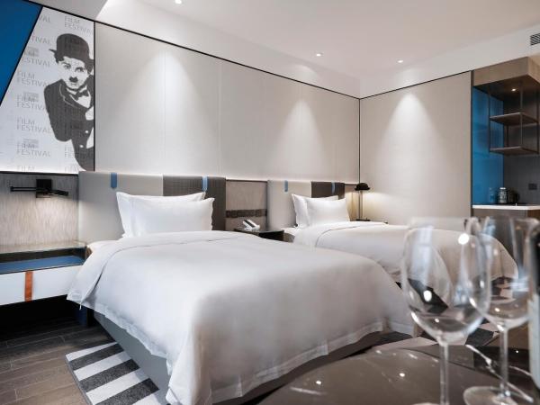 Qingdao Oriental Studio Chuangzhi SSAW Hotel : photo 3 de la chambre chambre affaires lits jumeaux