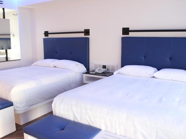 WeEnjoy Hotels Grand Prix Aeropuerto CDMX : photo 2 de la chambre chambre double avec 2 lits doubles