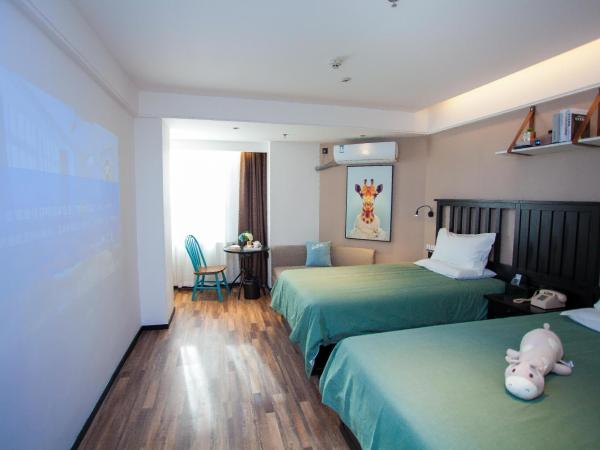 银座精宿(黄岛金沙滩香江路商业街店) : photo 4 de la chambre selected twin room with audio 