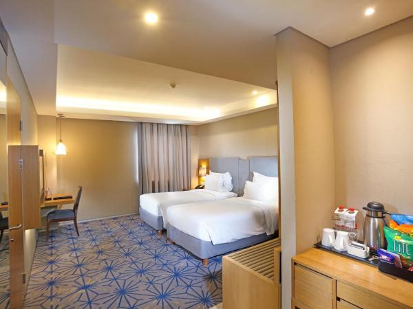 Swiss-Belhotel Pondok Indah : photo 1 de la chambre hébergement lits jumeaux deluxe supérieur