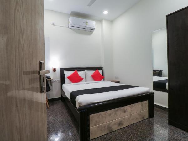 Capital O GN Suites : photo 2 de la chambre petite chambre double