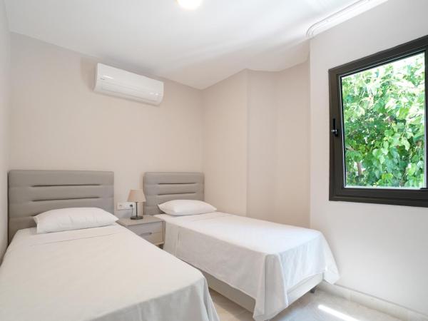 Olira Türkbükü Residences : photo 4 de la chambre appartement - vue sur jardin